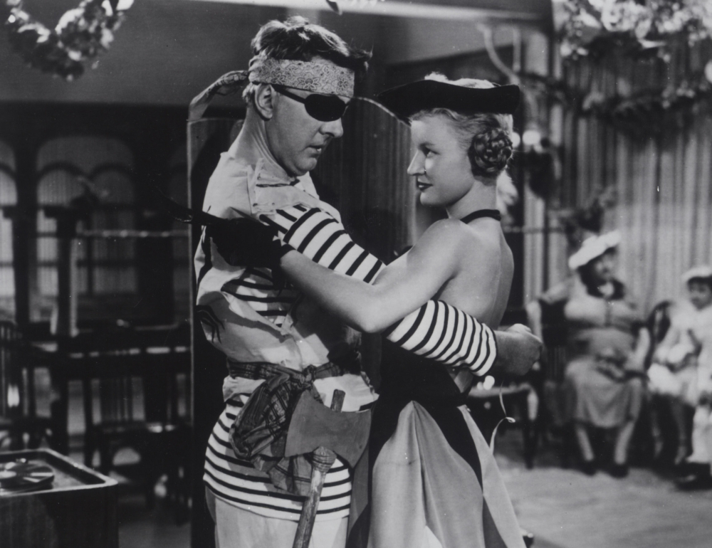 Two people dressed as pirates hold eachother in a dance ready position