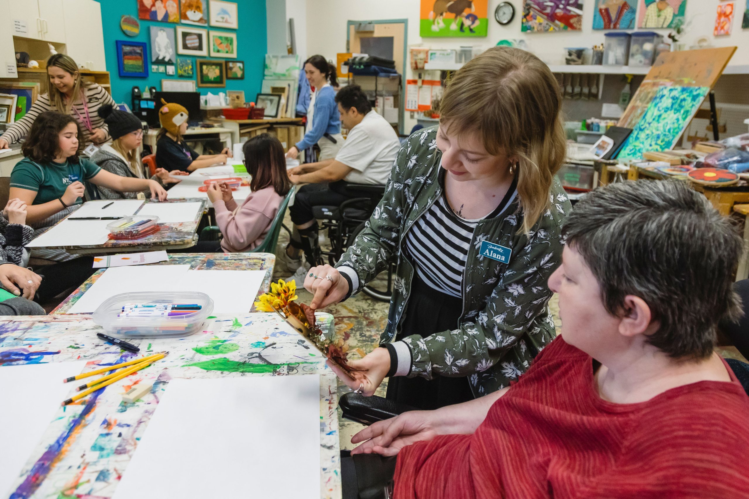 A senior and a staff member make art together at Sherbrooke Community Centre.