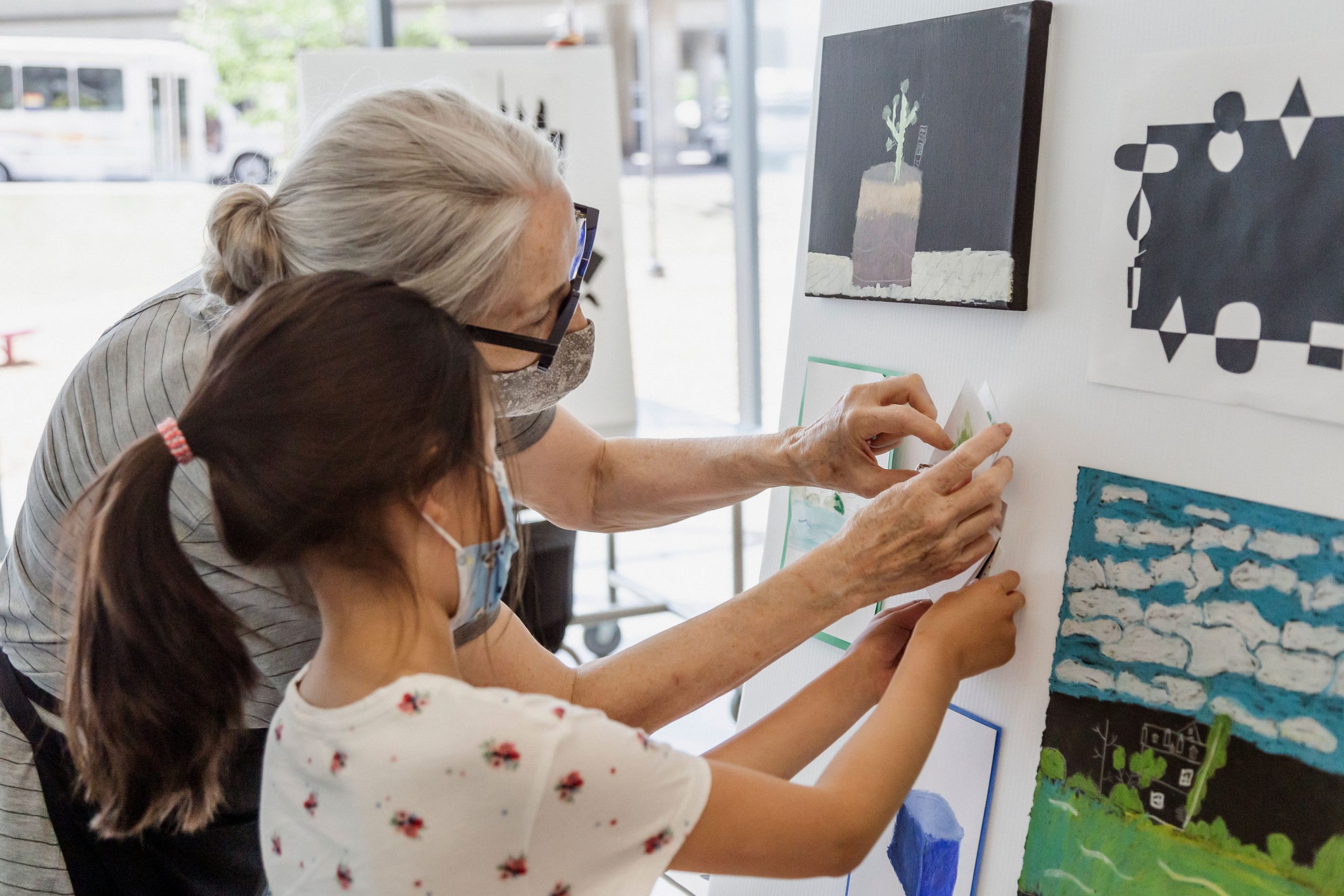 A child and art instructor make art in Remai Modern's learning studio.