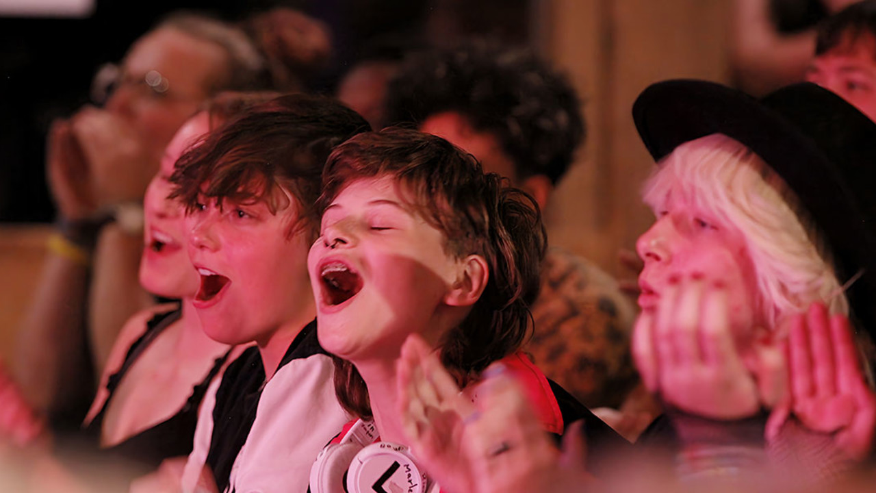 Children sing together at a summer camp.
