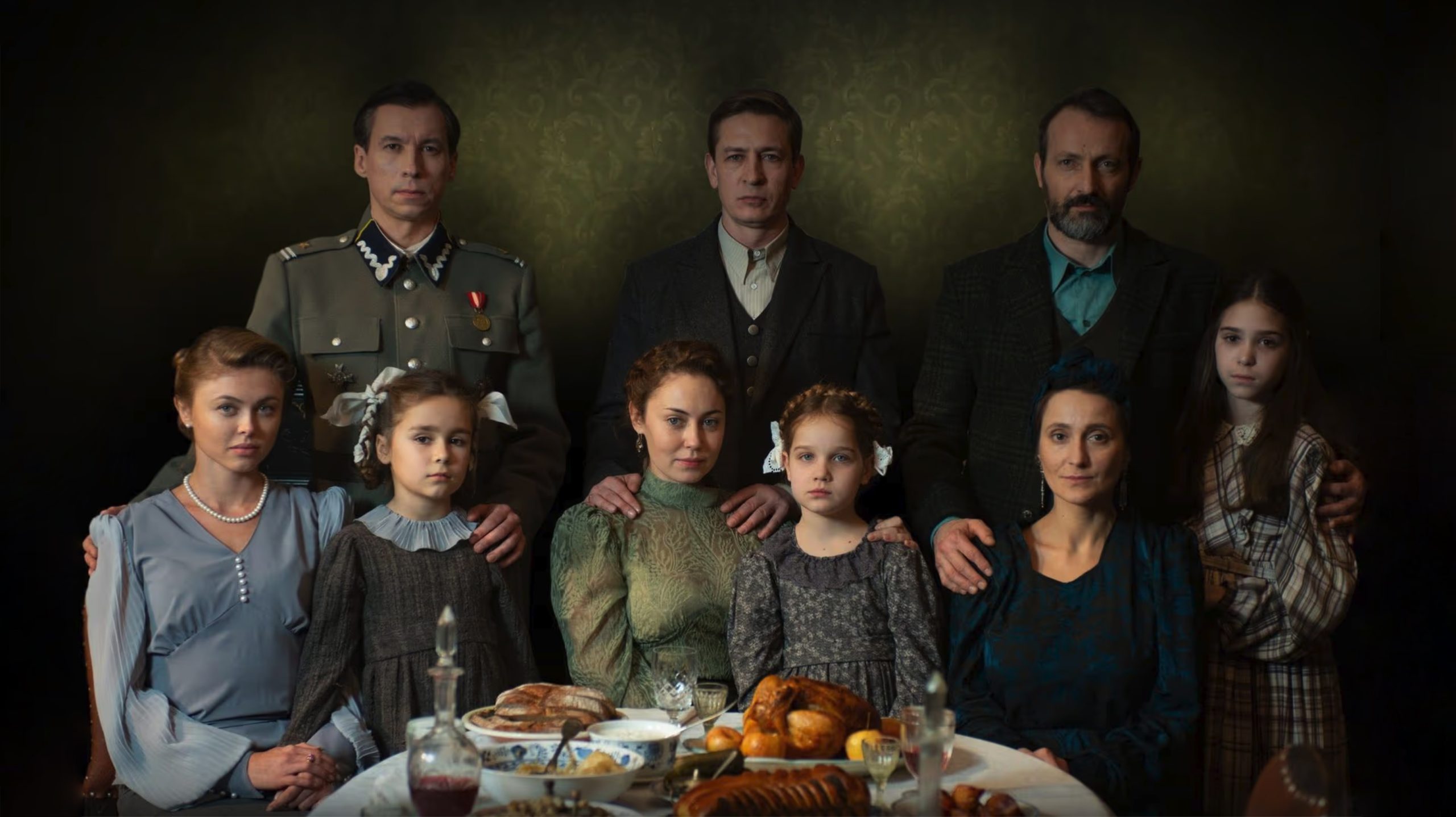 A promo photo from the movie Shchedryk shows a family seated around a dinner table in the 1940s during the Second World War.