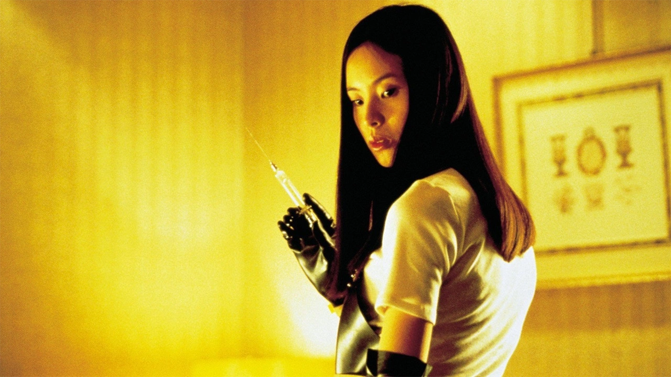 "A photo of a lady holding a syringe with a black glove"